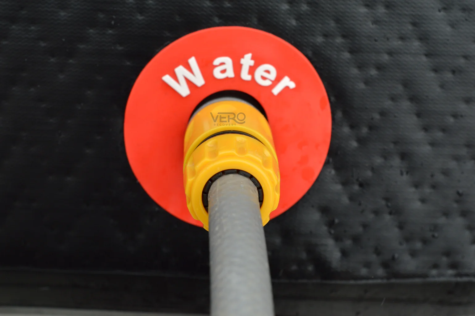 Vero Recovery Ice Bath Hose Connector fitted to the water outlet with a hose attached